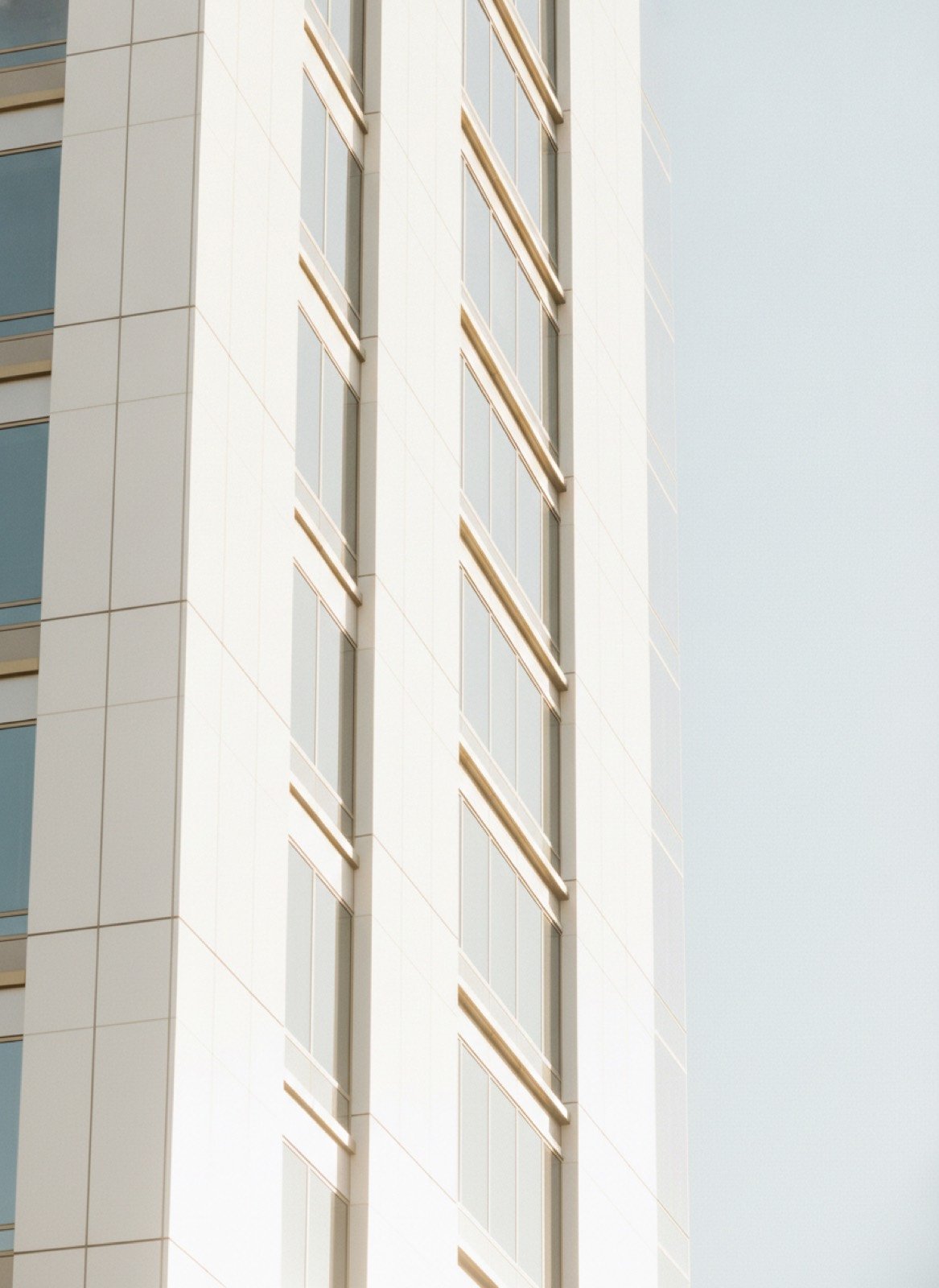 Bright white modern high-rise architecture in Los Angeles against a pale sky