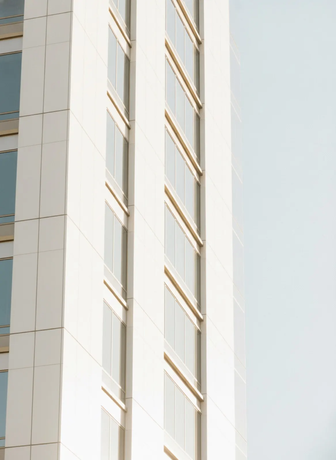 Bright white modern high-rise architecture in Los Angeles against a pale sky